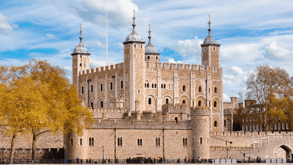 Tower of London with stone walls and historic battlements under a blue sky